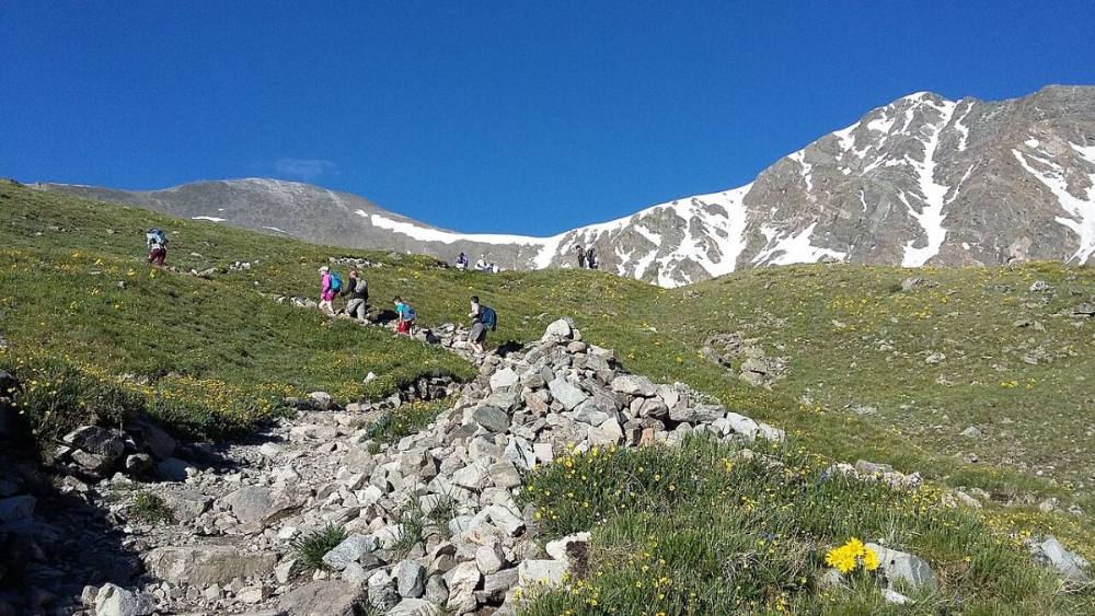 Hikers on the valley trail with both peaks ahead